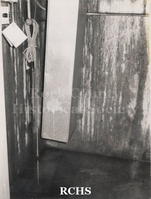 Black and white photograph of a water damaged wall in the Stone House.