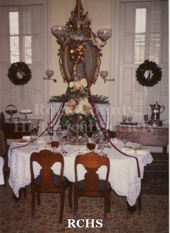 Color photo of a festively decorated table in the Tallman House dining room.