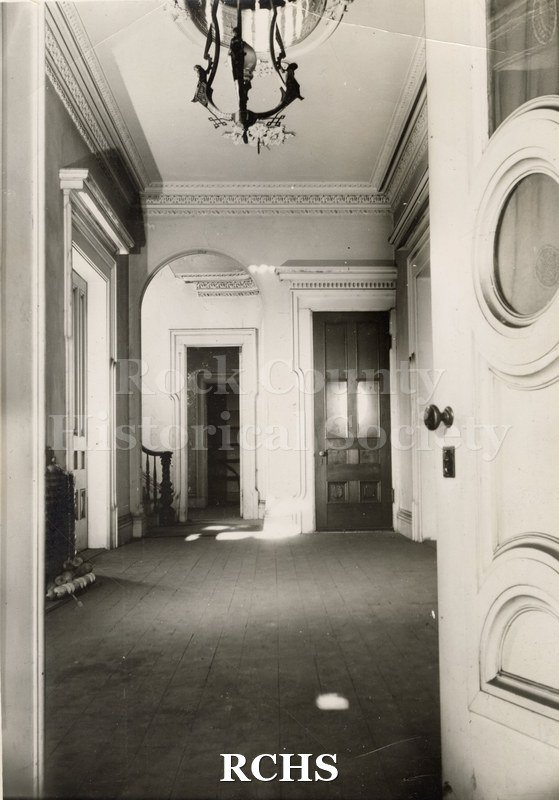 Black and white photograph of the front hall of the Tallman House.