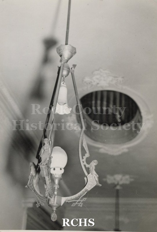 Black and white photograph of the gas light in the front hall of the Tallman House.