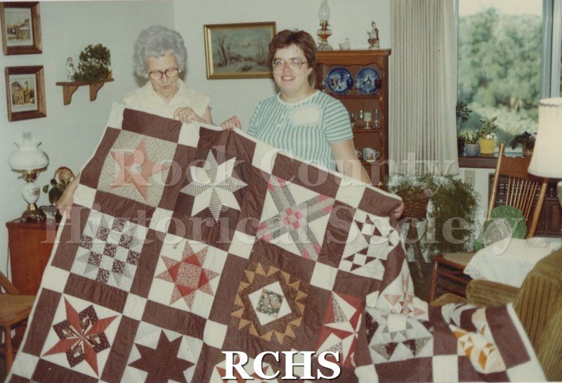 Color photo of the "Star Sampler" quilt made and raffled by members of the Rock Valley Quilters Guild and displayed by them at the 1982 Tallman Festival.