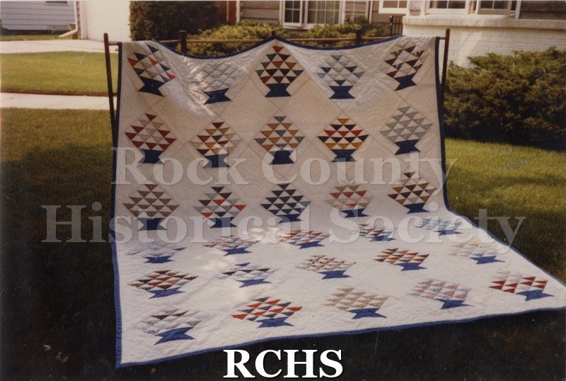 Color photo of a quilt raffled at the 1983 Tallman Festival, made by members of the Rock Valley Quilters Guild.