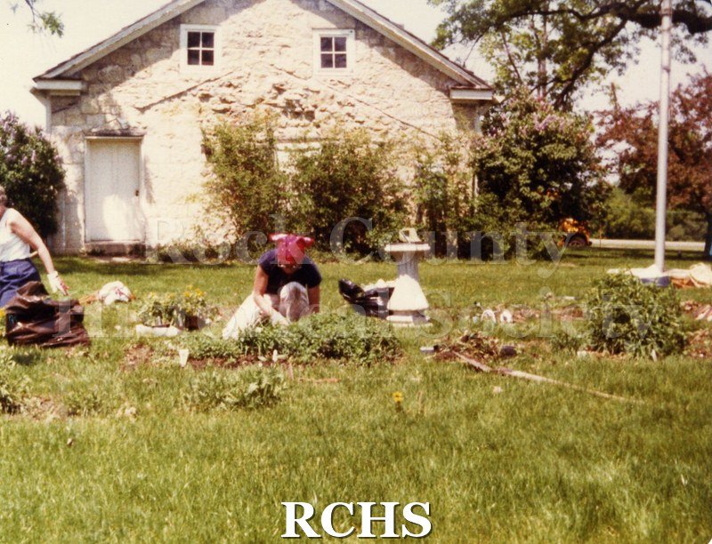 Color photo of several women working in a garden on the Tallman campus.