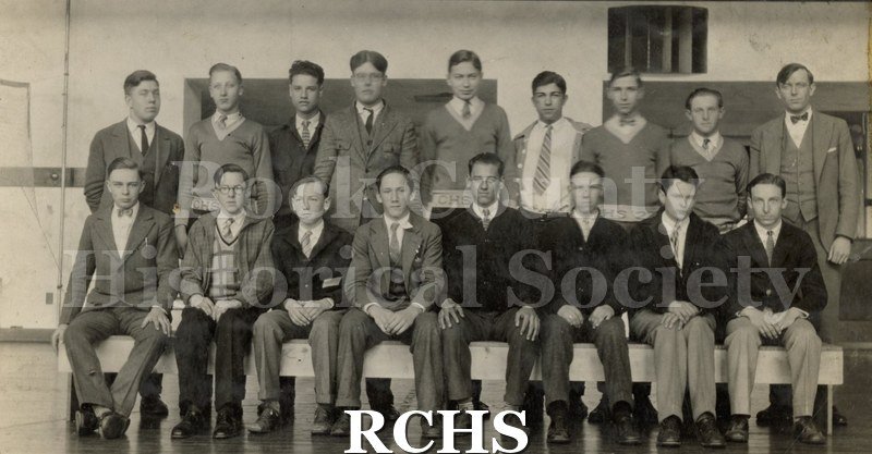 Blackand white photograph of several men sitting and standing.