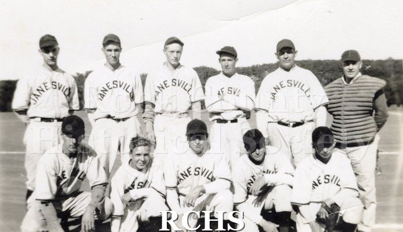 Black and white photograph of Ray Blum's Janesville Merchants baseball team of ten men and the coach.
