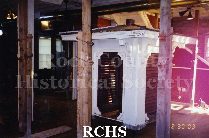 Color photo of the interior of the Carriage House with construction work being done. The cupola is on the floor.
