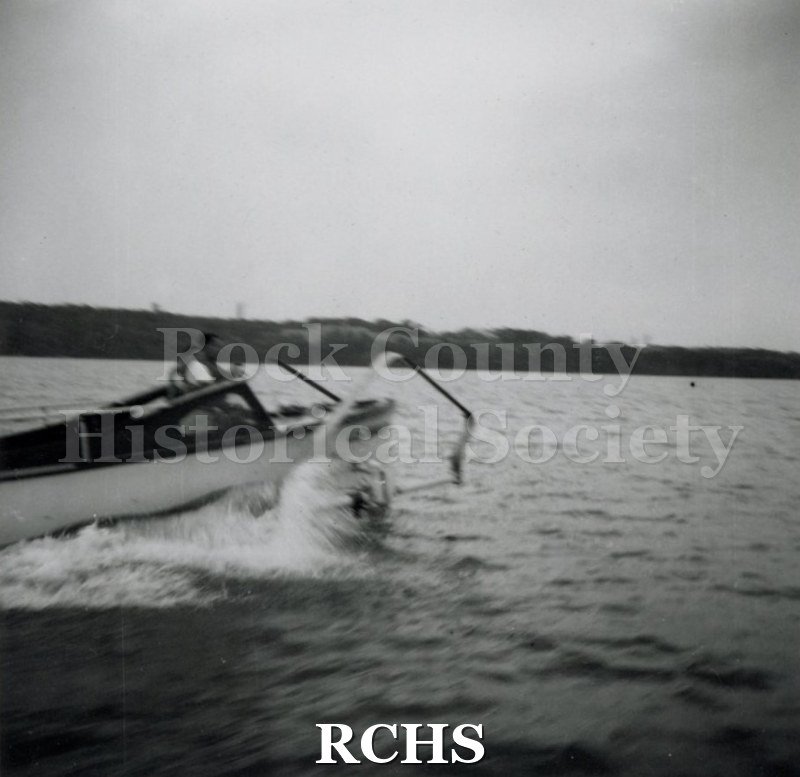 Black and white photograph of "High Pockets" moving through the water with at least one man on board. On separate card: "High Pockets" "13".