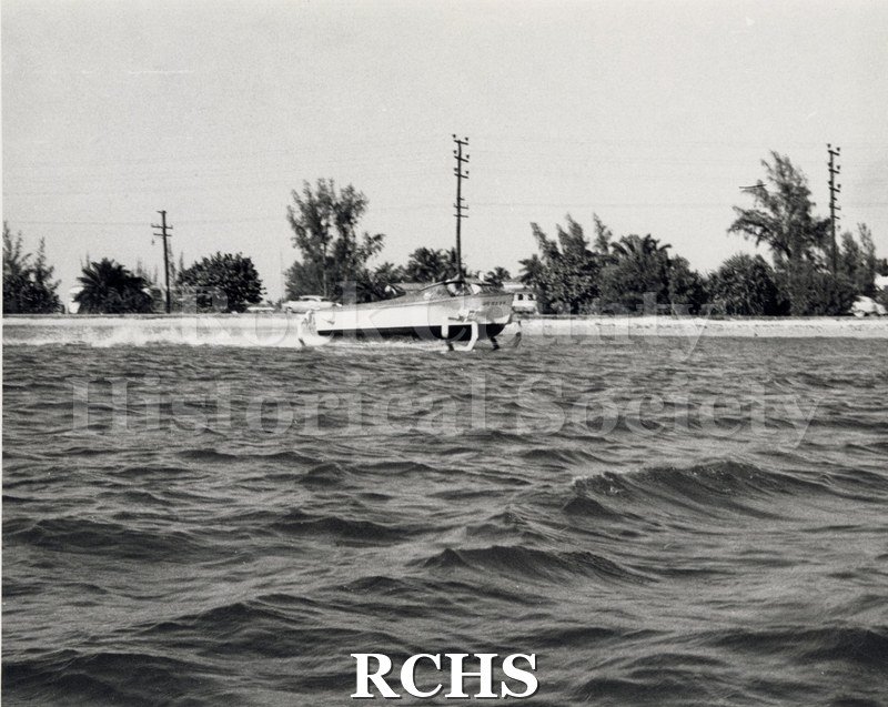 Black and white photograph of "High Pockets" on the water in Miami, FL, with one man aboard. On separate card: "High Pockets Single foil aft Along Flagler Dr.