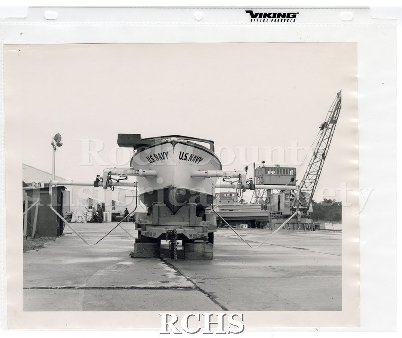 Black and white photograph of "High Pockets" on a trailer with the words: "U.S.Navy" visible on each side of the front.