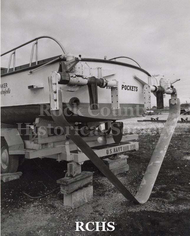 Black and white photograph of "High Pockets" on a trailer. The words "High Pockets" are painted on the back. The trailer has the words: "U.S. Navy ONR 238" on it.