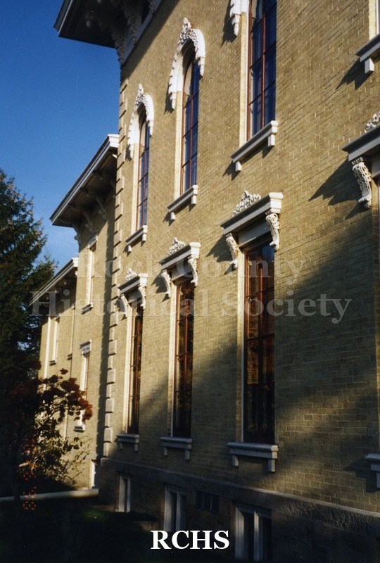 Historic image of Tallman House in the sunlight. Transcription: "Monty" and "Photographer: Judy Meisner.".
