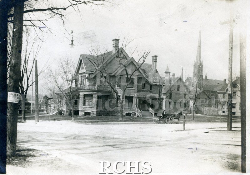 Black and white photograph of Dr. James Mills' Residence, a three story house with a front porch and side porch.