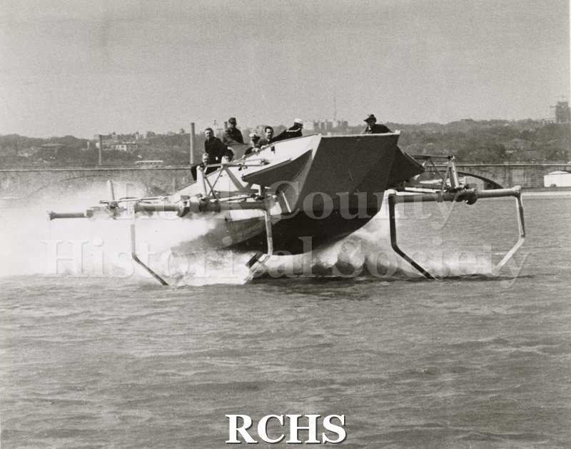 Black and white photograph of "High Lander" in the water with several people on board. On separate card: "Chief Petty Officer Sheehan-VDT at helm J. G.