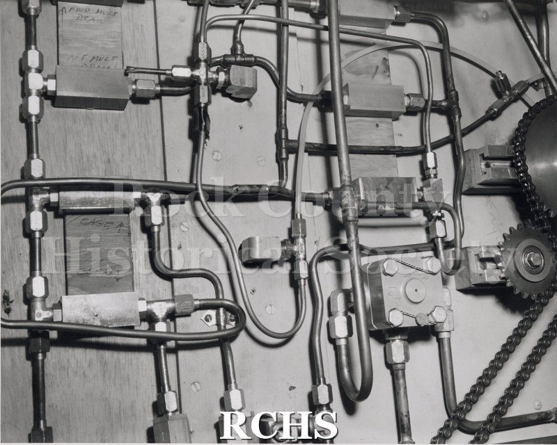 Black and white photograph of a close-up shot of hydraulic circuit in the "High Tail".