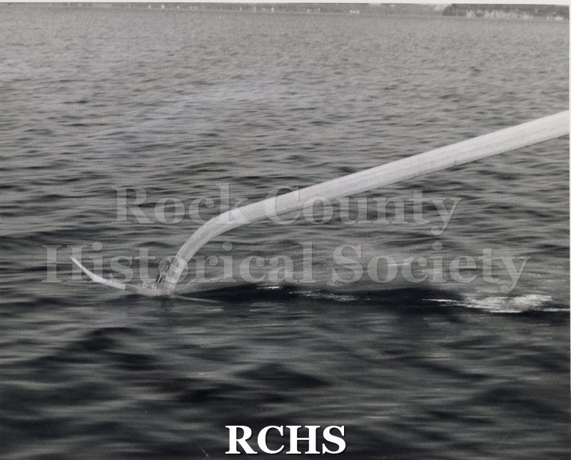 Black and white photograph of a close-up of ski only. Photographer: "Black Photo Service 305 University Ave. Madison, Wisconsin Commercial Photography.