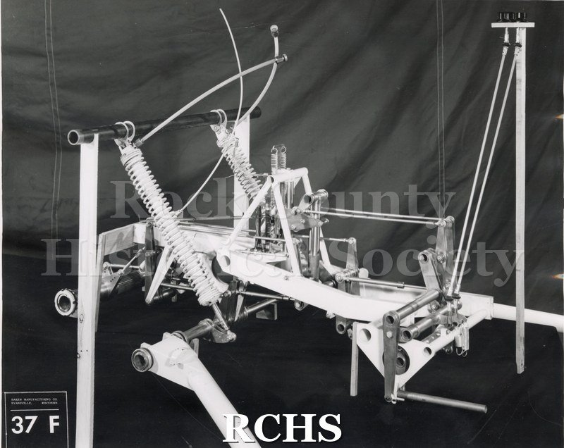 Black and white photograph of "High Tail" rear mechanical computer-located in front compartment On bottom: Baker Manufacturing Co.