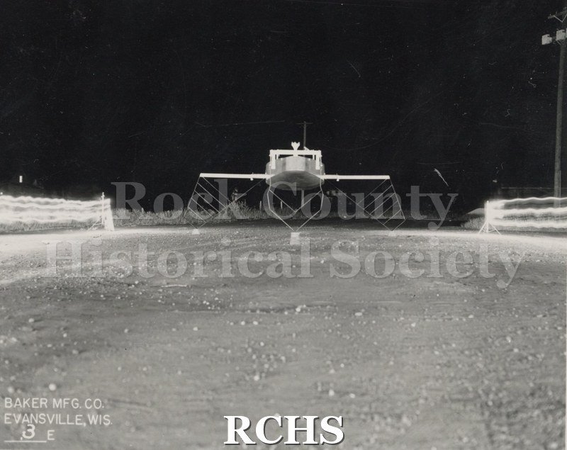 Black and white photograph of the Monitor Hydrofoil without sail; foils down from the side. On bottom: Baker Mfg. Co. Evansville, Wis 5E" Photographer: H. C.