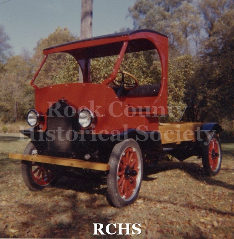Color photo of a Samson truck. There is no license on it. It is parked near some trees.