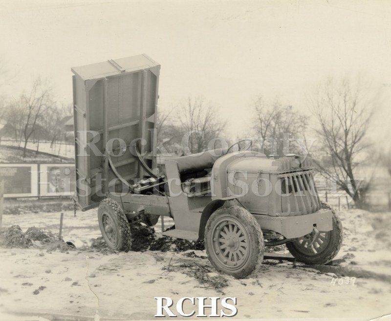 Black and white photograph of a dump truck from Highway Trailer Co., Edgerton, WI. The dump truck has the trailer in an upright position.
