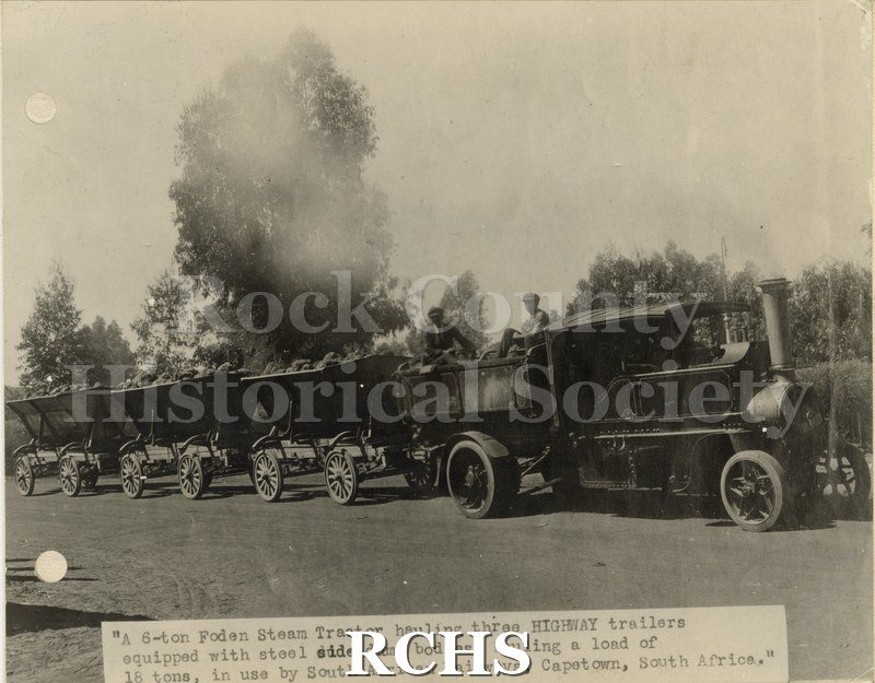 Black and white photograph of the multi-purpose trailers from Highway Trailer Co., Edgerton, WI. Shows a tractor pulling three trailers loaded with coal.