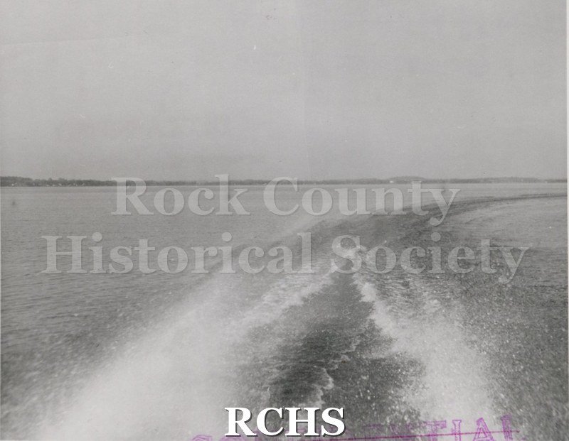 Black and white photograph of "High Pockets" with two men aboard. On front of craft is: "USNAVY".