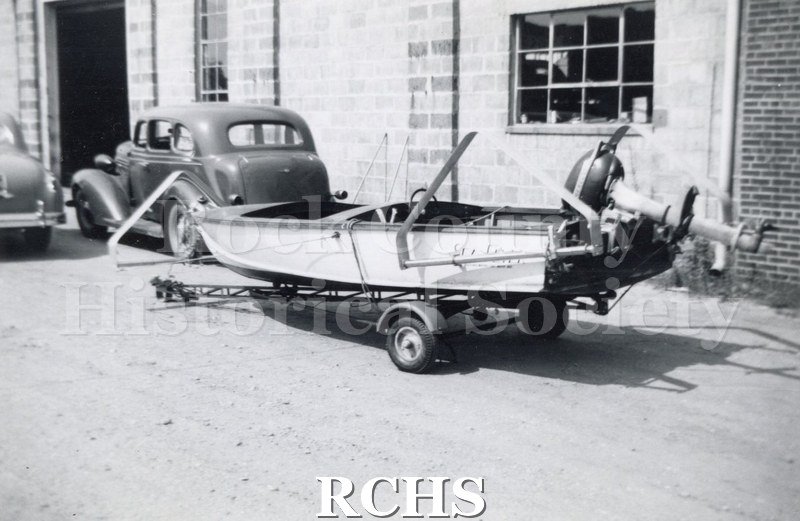 Black and white photograph of "Sea Flyer" shown on a trailer with the engine up and the name "Sea Flyer" on the side.