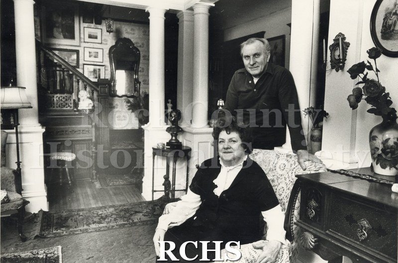 Black and white photograph of Mr. & Mrs. Vern Eldridge in the living room of their house at 115 S. High St., Janesville, WI.