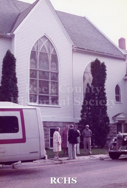 Historic image of Tinted photogrpah of men and women standing outside the Jefferson Prairie Lutheran Church in September 1983.