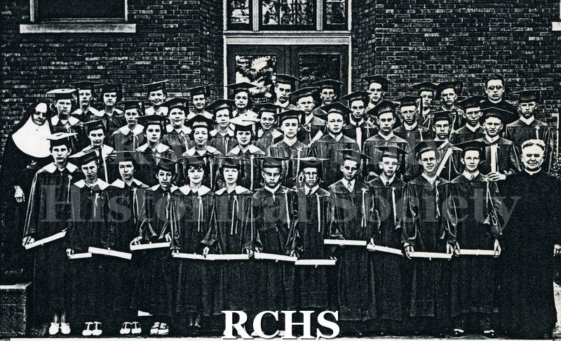 Xerox Black and white photograph of graduates of St. Patrick's Junior High School, Janesville, WI, June 10, 1934, wearing caps and gowns.