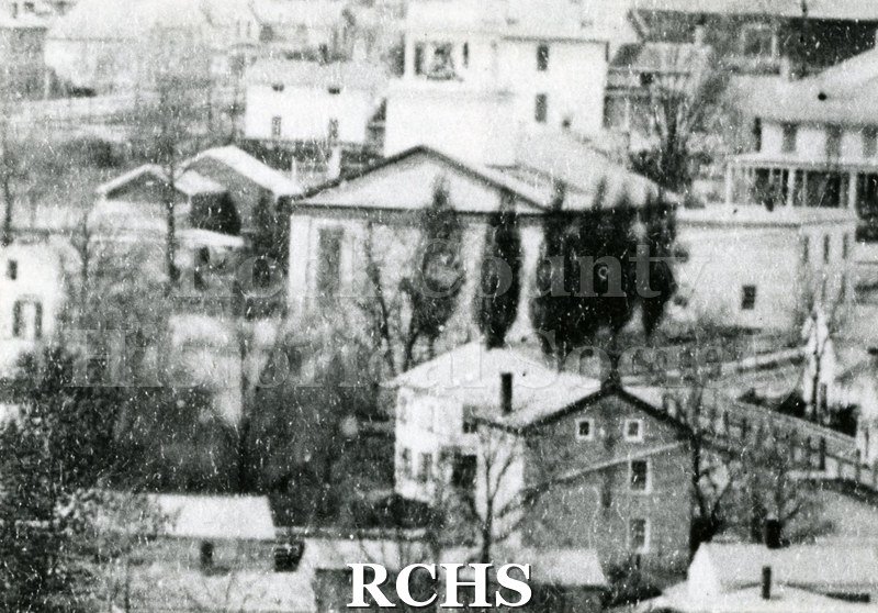 Black and white photograph of First Baptist Church among other buildings.