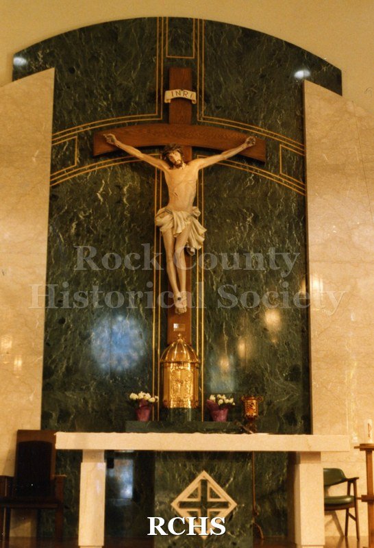Color photo of St. Patrick's Catholic Church, Janesville, WI, showing the crucifix above the altar.