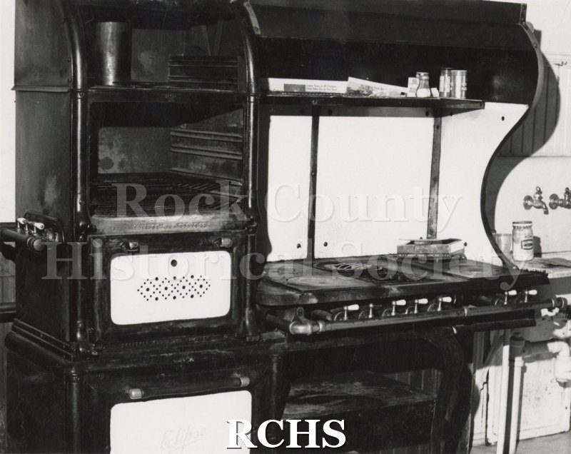 Black and white photograph of the Pliny Norcross-David Holmes residence. Shows an old stove with the oven on the left and the burners on the right.