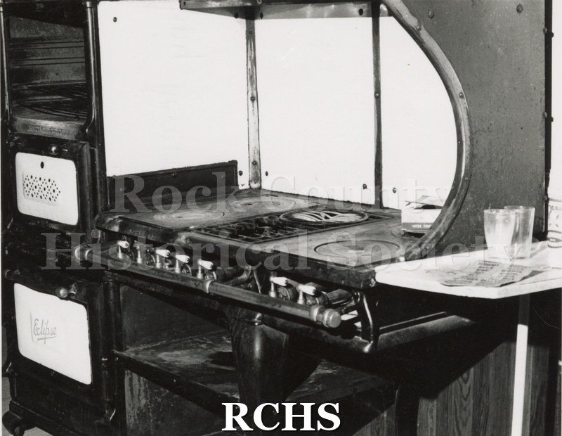 Black and white photograph of the Pliny Norcross-David Holmes residence. Shows an old stove with the oven on the left and the burners on the right.