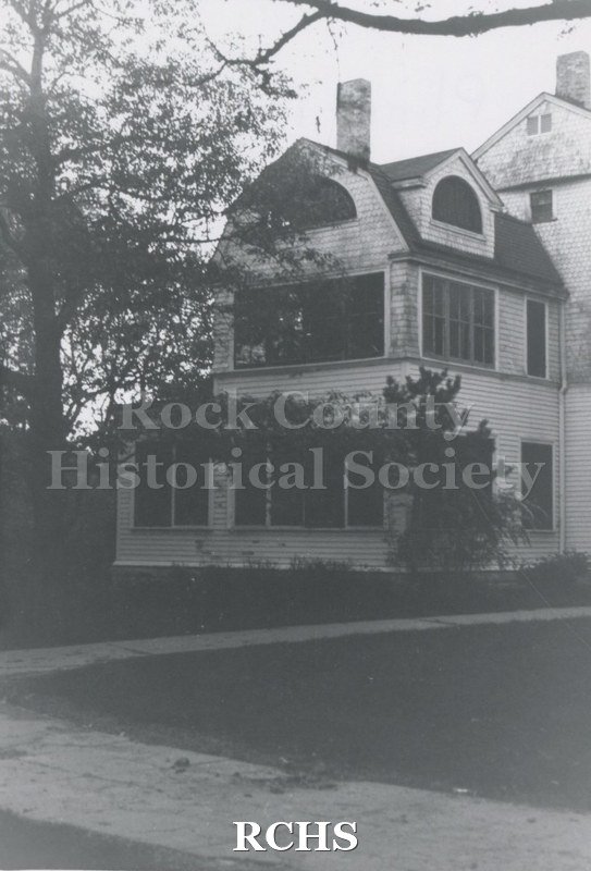 Black and white photograph of the Pliny Norcross-David Holmes residence. Shows a three story house that has fallen in disrepair.