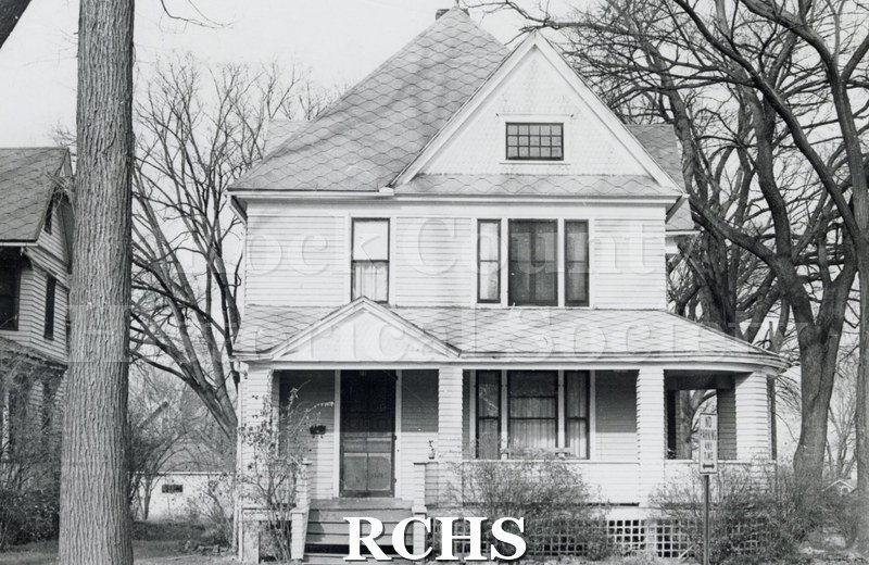 Black and white photograph of 1002 Mineral Point, Janesville, WI (demolished c. July 1, 1971). Shows a three story house with a roofed porch across the front.