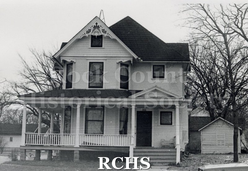 Black and white photograph of 1003 Olive St., Janesville, WI, demolished c. July 1, 1971. Shows a two story house with a peaked roof.