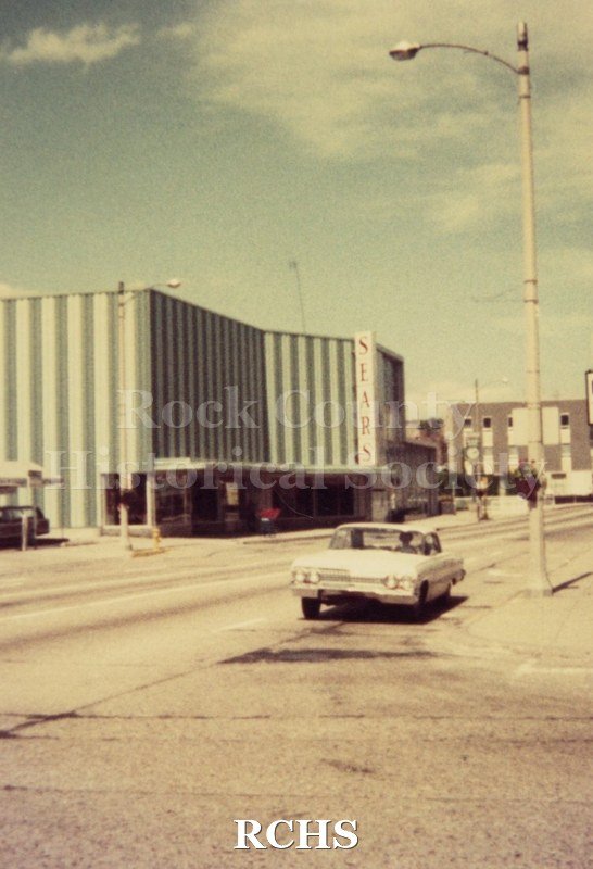 Historic image of Color photogrpah of the Sears store with "Sears" sign on the front.