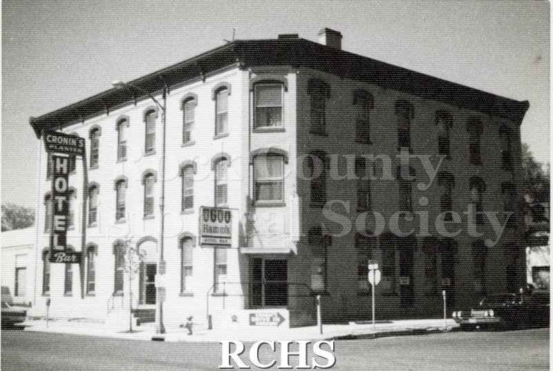 Black and white photograph of Cronin's Planter's Hotel and Bar. Shows a three story building with the sign: "Cronin's Hotel" on the side.