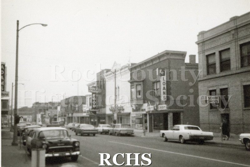 Black and white photograph of South River St., Janesville, WI. Shows early Janesville stores.