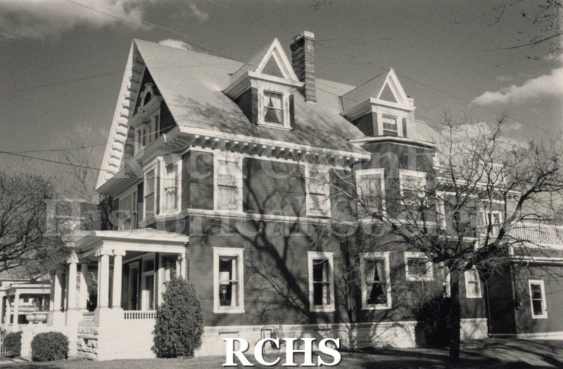 Black and white photograph of 802 E. Court, a three story house shown from the side with many windows and two dormers.