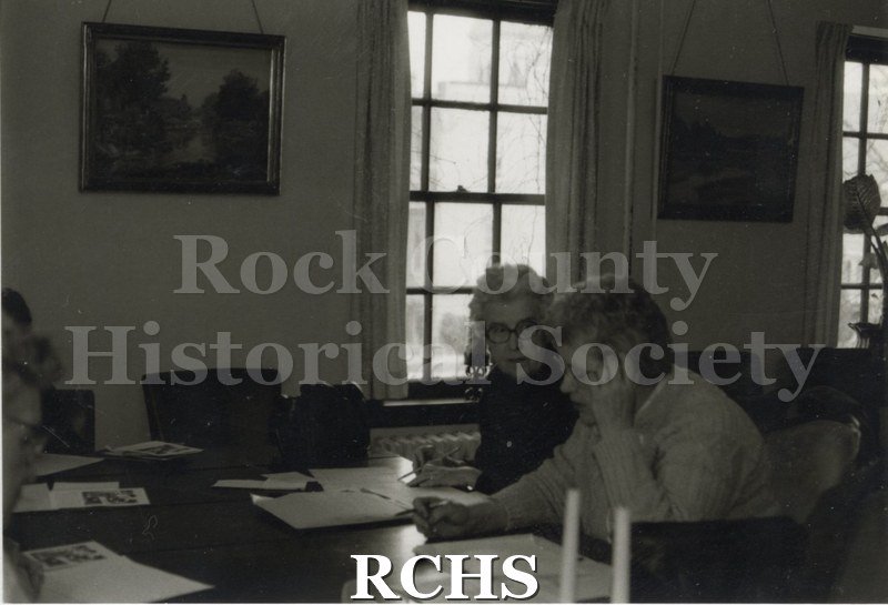 Black and white photograph of Clarice Bergerson and Gretchen Albert working on lessons at the Historical Society building.