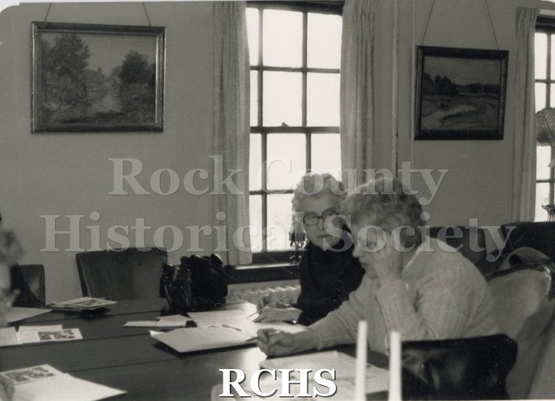 Black and white photograph of Clarice Bergerson and Gretchen Albert working on lessons at the Historical Society building.