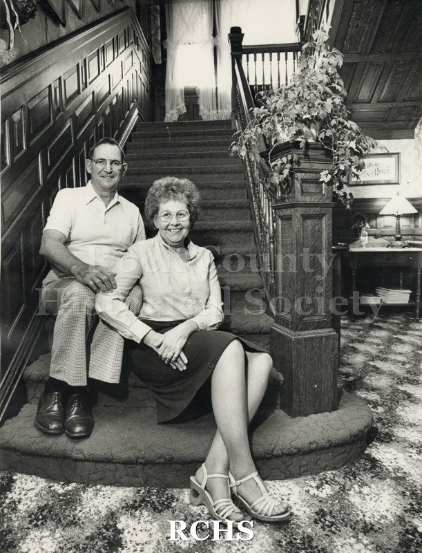 Black and white photograph of Robert and Ilah Sessler sitting on the steps of a stairway.