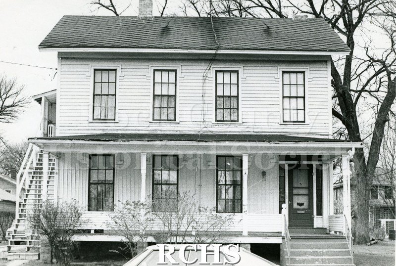 Black and white photograph of 539 Terrace St., Janesville, WI. Shows a two story house with four windows on the second floor and three windows to the left of the.