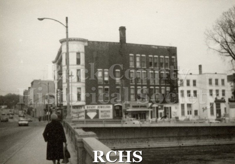 Black and white photograph of the Hayes Block building from the river.