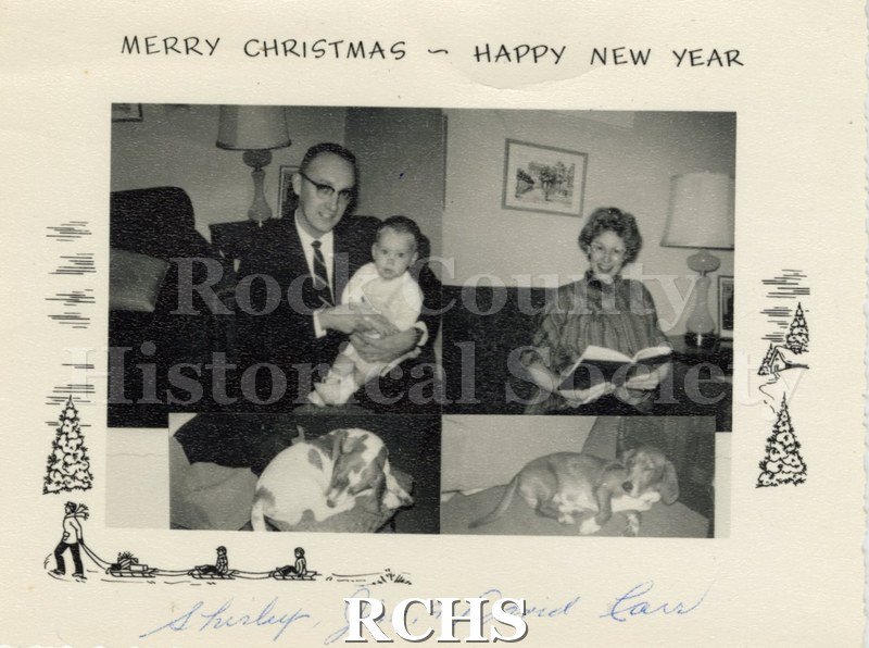 Historic image of Christmas card with four insert photographs. On top left is a man holding a child; top right is a woman sitting and holding a book; and bottom two.