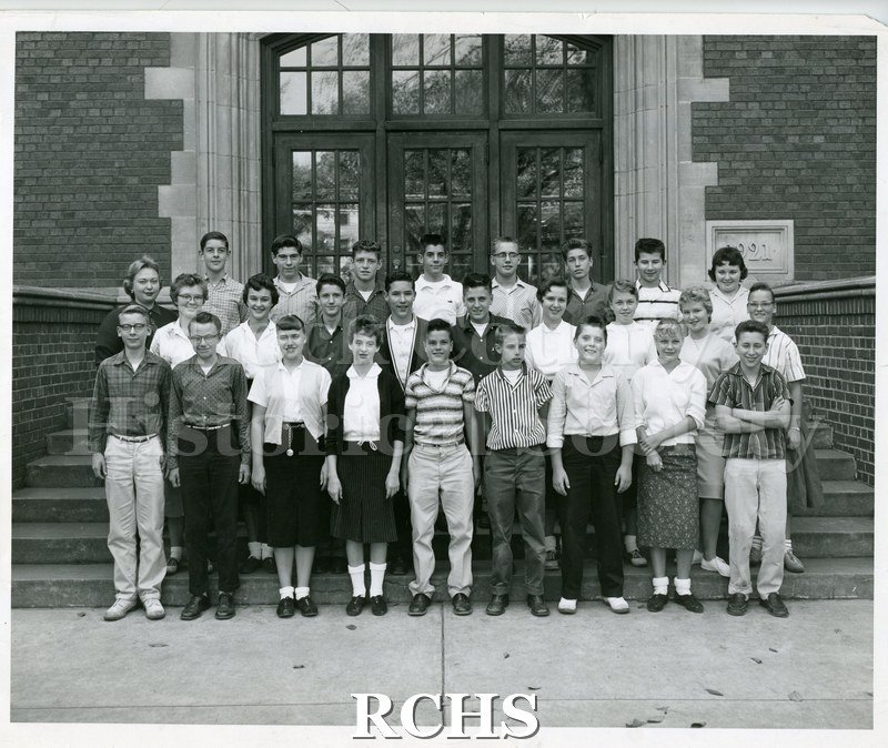 Black and white photograph of the Janesville Junior High School 1959 8th Grade Class is standing on the steps of Marshall Junior High School.