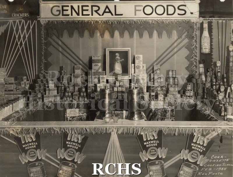 Black and white photograph of exhibits for General Foods. Included are Maxwell House Coffee; Corn flakes, etc. On bottom: "Carr-Gazette Cooking School Feb.