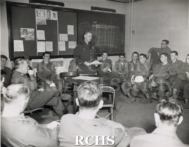 Black and white photograph of the Janesville Armory (N. E. Room ) 3 mos. inspection critique, circa 1949.