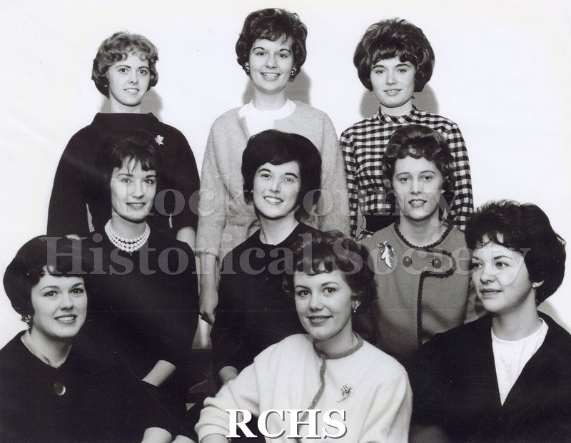 Black and white photograph of Miss Pennette Marcia Manogue and court. Shows 9 women, standing and seated in three rows of three.